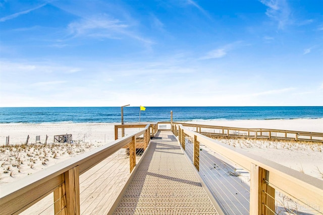 exterior space with a water view and a beach view