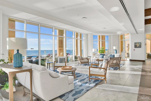 living room featuring floor to ceiling windows and a water view