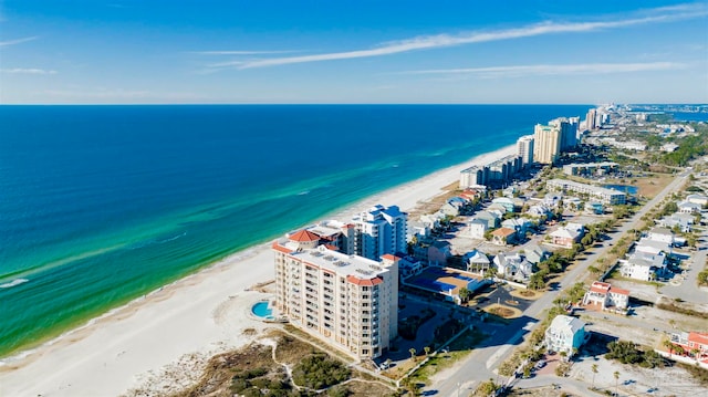 drone / aerial view featuring a water view and a view of the beach