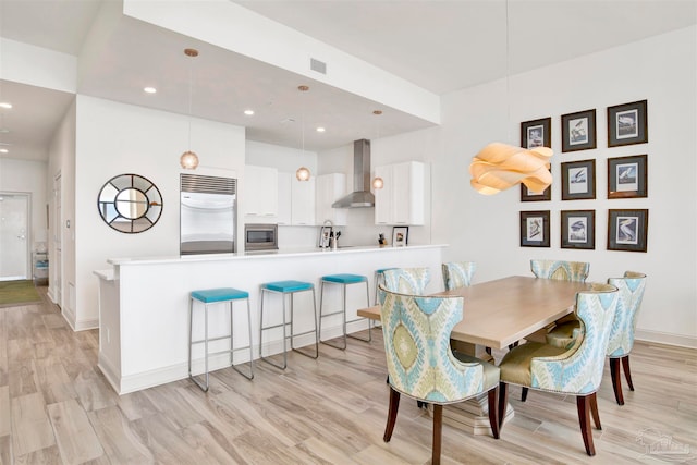 dining area featuring light hardwood / wood-style floors and sink