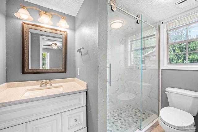 bathroom featuring a textured ceiling, toilet, a marble finish shower, and visible vents