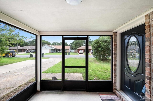 unfurnished sunroom with a residential view