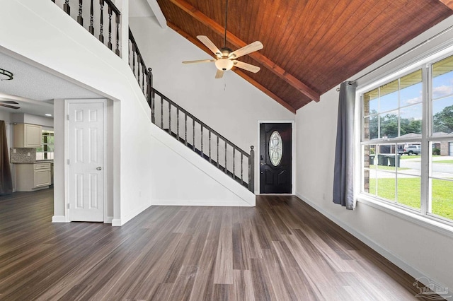 foyer with stairway, dark wood-type flooring, high vaulted ceiling, wooden ceiling, and baseboards