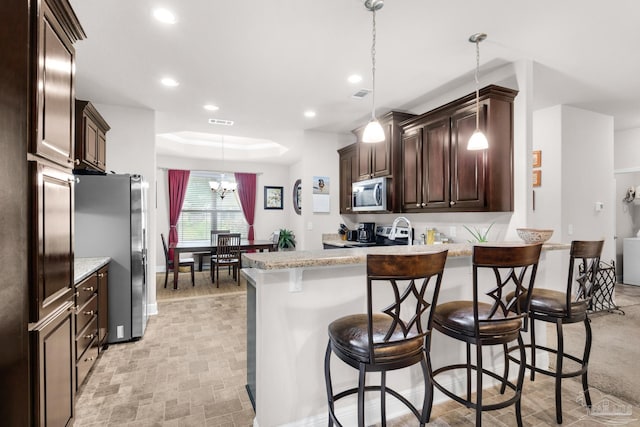 5282 Parkside Dr, Pace, FL 32571 - kitchen featuring stainless steel appliances, dark brown cabinets, recessed lighting, a peninsula, and a breakfast bar area
