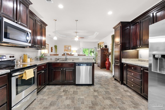 5282 Parkside Dr, Pace, FL 32571 - kitchen with appliances with stainless steel finishes, stone finish floors, recessed lighting, a ceiling fan, and a peninsula