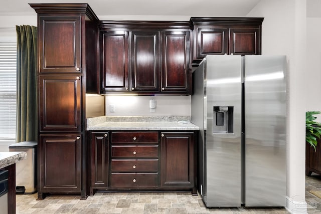 5282 Parkside Dr, Pace, FL 32571 - kitchen with stainless steel fridge, dark brown cabinetry, stone finish flooring, and light stone counters