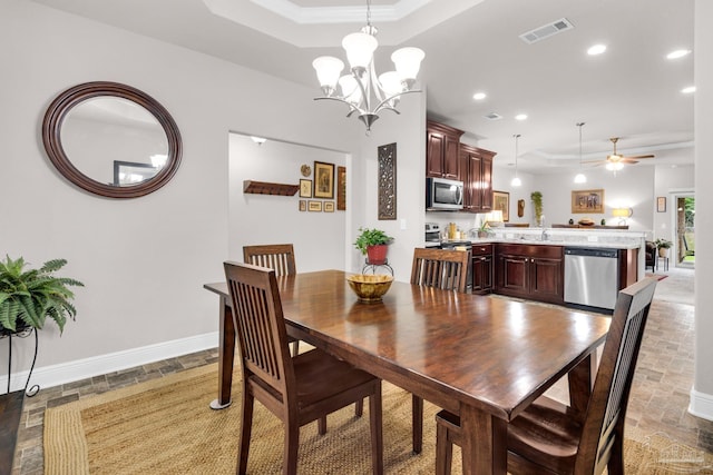 5282 Parkside Dr, Pace, FL 32571 - dining space featuring a raised ceiling, recessed lighting, ceiling fan, ornamental molding, and a chandelier