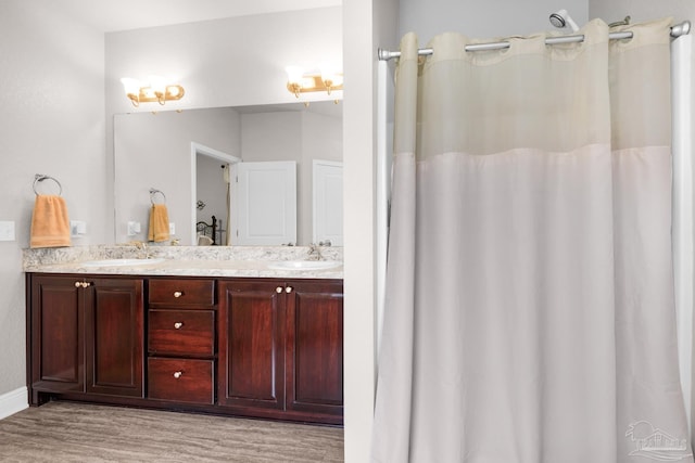 5282 Parkside Dr, Pace, FL 32571 - full bathroom featuring double vanity and wood finished floors