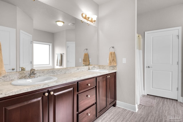 5282 Parkside Dr, Pace, FL 32571 - full bathroom with double vanity and wood finished floors