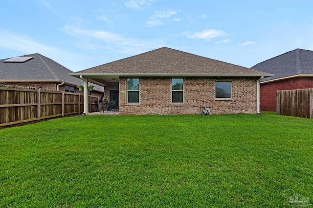 5282 Parkside Dr, Pace, FL 32571 - back of house with brick siding, a fenced backyard, and roof with shingles