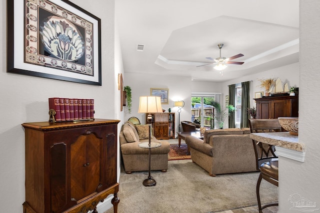 5282 Parkside Dr, Pace, FL 32571 - living area featuring ceiling fan, a tray ceiling, and carpet flooring