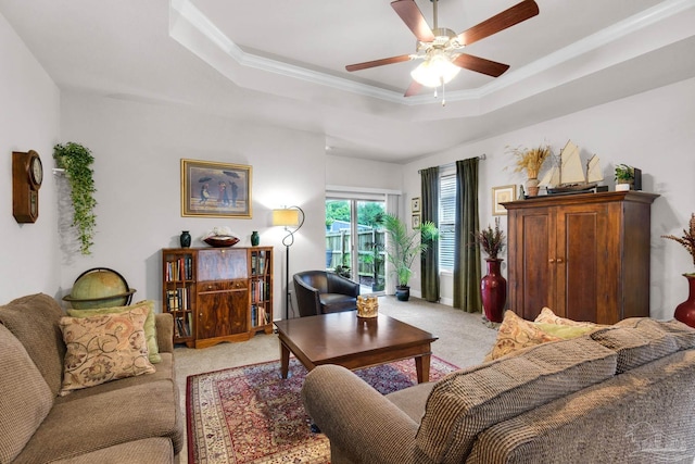 5282 Parkside Dr, Pace, FL 32571 - living room featuring light colored carpet, ceiling fan, a tray ceiling, and ornamental molding