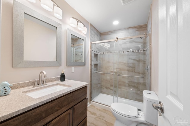 bathroom with toilet, a shower with shower door, and vanity