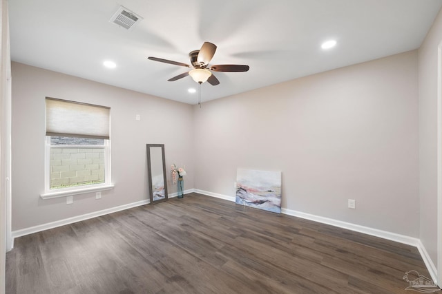 unfurnished room featuring ceiling fan and dark wood-type flooring