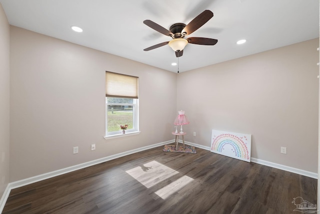 empty room with ceiling fan and dark wood-type flooring