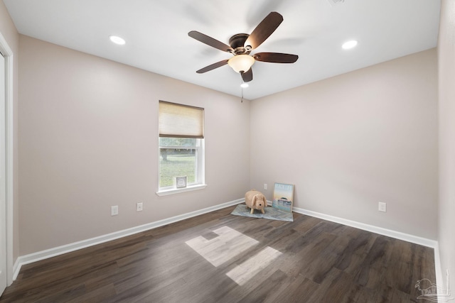 empty room with ceiling fan and dark wood-type flooring