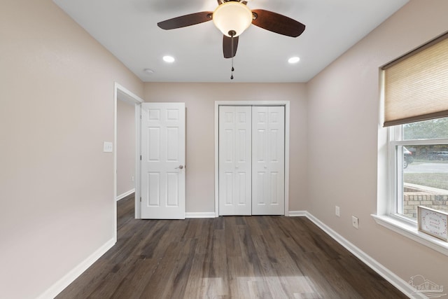 unfurnished bedroom featuring a closet, ceiling fan, and dark wood-type flooring