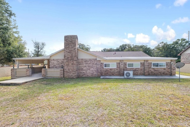 rear view of property with a lawn and ac unit