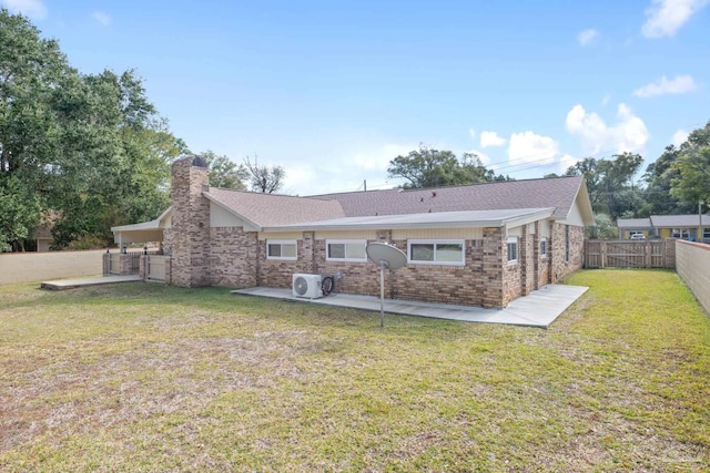 rear view of house featuring a lawn, ac unit, and a patio area