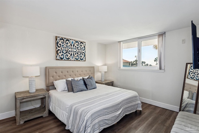 bedroom with dark hardwood / wood-style flooring