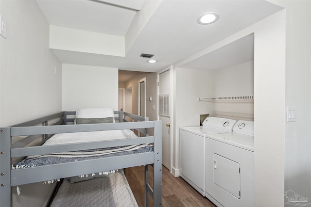 laundry area featuring washer and clothes dryer and hardwood / wood-style floors