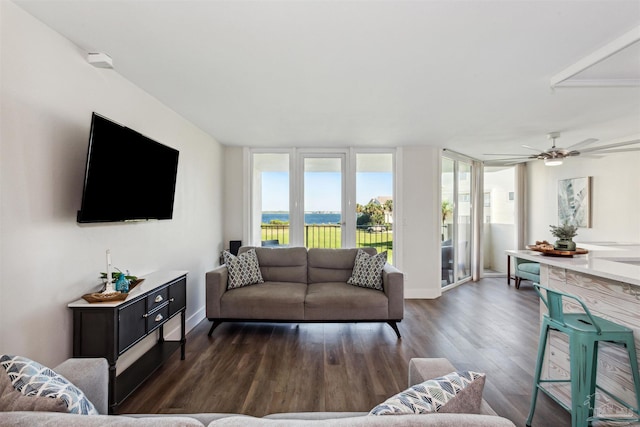 living room with dark wood-type flooring and ceiling fan