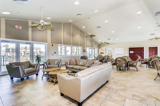 tiled living room featuring high vaulted ceiling, ceiling fan, and french doors