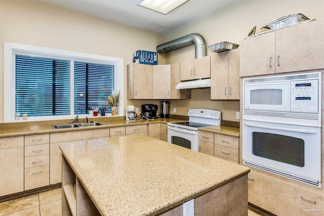 kitchen featuring light stone counters, light brown cabinets, white appliances, sink, and light tile patterned floors