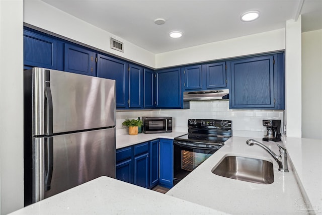 kitchen featuring blue cabinets, sink, backsplash, stainless steel appliances, and light stone countertops