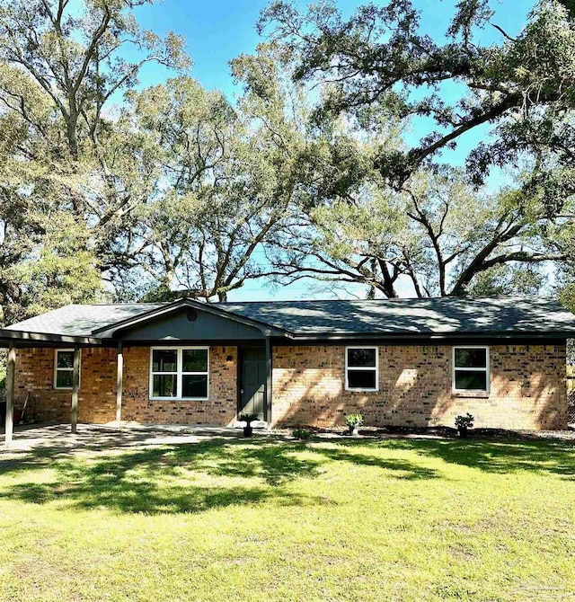 single story home with brick siding and a front yard