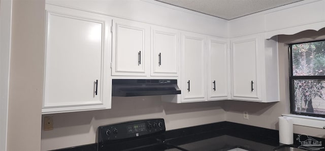 kitchen with white cabinets, stove, a textured ceiling, and sink