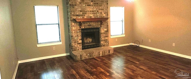 unfurnished living room with dark hardwood / wood-style flooring and a fireplace