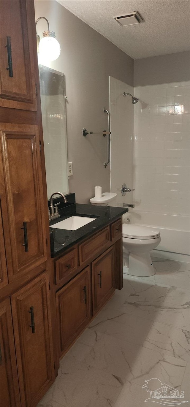 full bathroom with bathtub / shower combination, vanity, a textured ceiling, and toilet