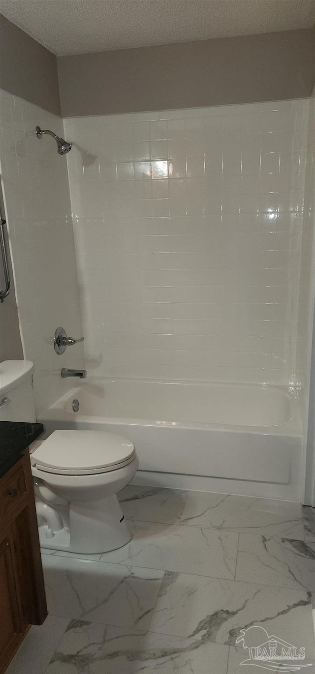 full bathroom featuring vanity, toilet, a textured ceiling, and bathtub / shower combination