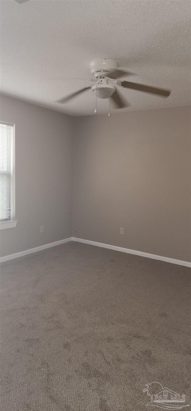 unfurnished room with ceiling fan, carpet floors, and a textured ceiling