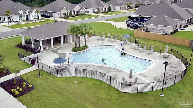 view of pool featuring a lawn and a patio area