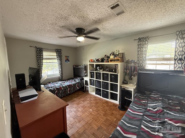 1515 Mariners Cir, Gulf Breeze, FL 32563 - bedroom with a ceiling fan, an office area, and a textured ceiling