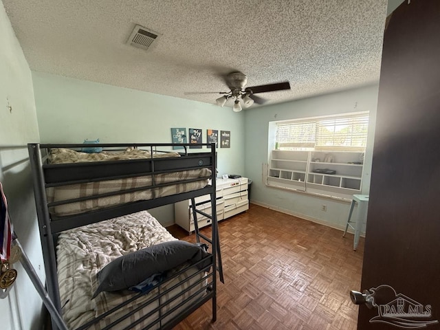 1515 Mariners Cir, Gulf Breeze, FL 32563 - bedroom with a textured ceiling, a ceiling fan, and baseboards