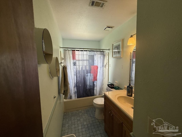 1515 Mariners Cir, Gulf Breeze, FL 32563 - bathroom featuring a textured ceiling, vanity, shower / bath combo with shower curtain, toilet, and tile patterned floors