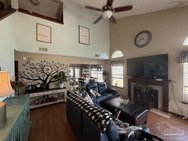 1515 Mariners Cir, Gulf Breeze, FL 32563 - living room featuring high vaulted ceiling, ceiling fan, a tile fireplace, and wood finished floors