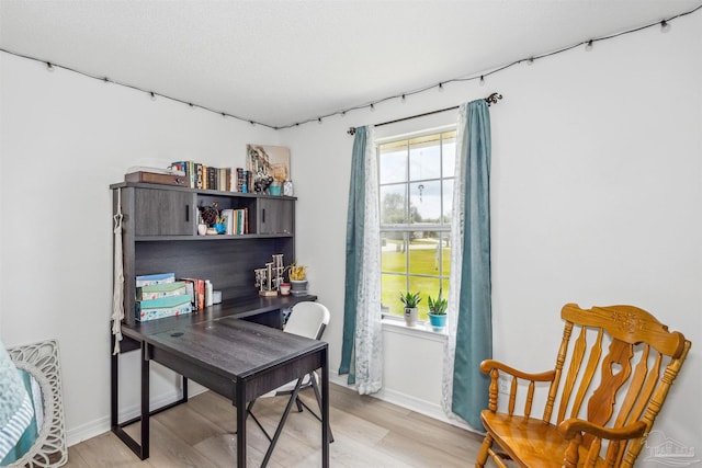 office area featuring baseboards and light wood-style floors