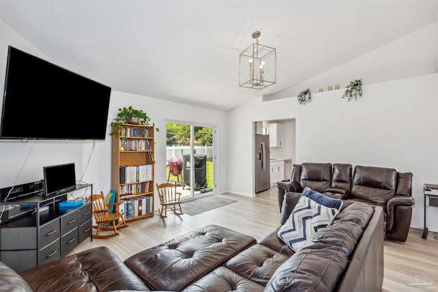 living area featuring lofted ceiling, light wood-type flooring, a chandelier, and baseboards