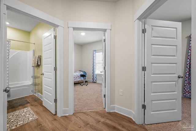 interior space featuring wood finished floors and baseboards