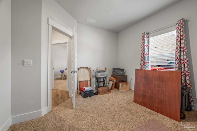 interior space featuring carpet flooring, visible vents, and baseboards