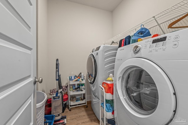 washroom with laundry area, wood finished floors, and independent washer and dryer