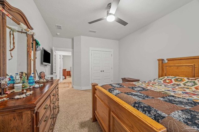 bedroom featuring ceiling fan, visible vents, baseboards, and light colored carpet