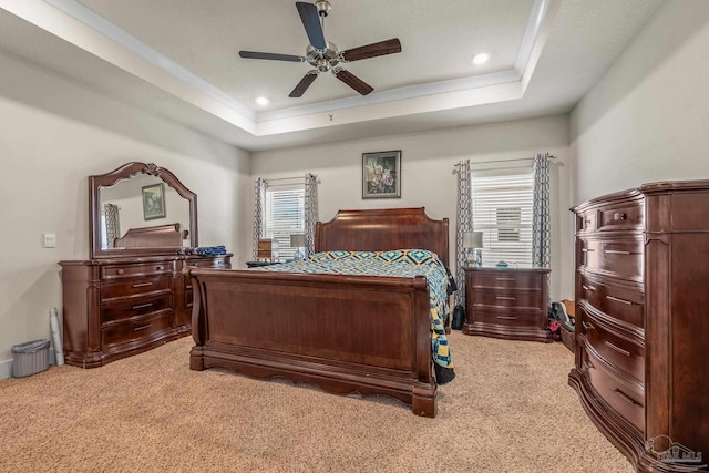 bedroom featuring light carpet, multiple windows, a raised ceiling, and recessed lighting