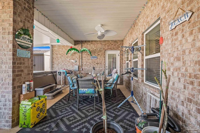 view of patio with a hot tub, a ceiling fan, and outdoor dining space