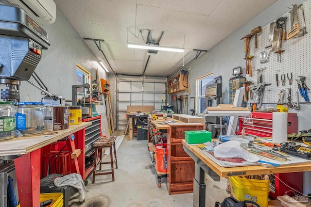 garage with a garage door opener, an AC wall unit, and a workshop area