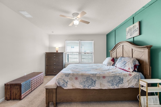 bedroom featuring ceiling fan and light carpet